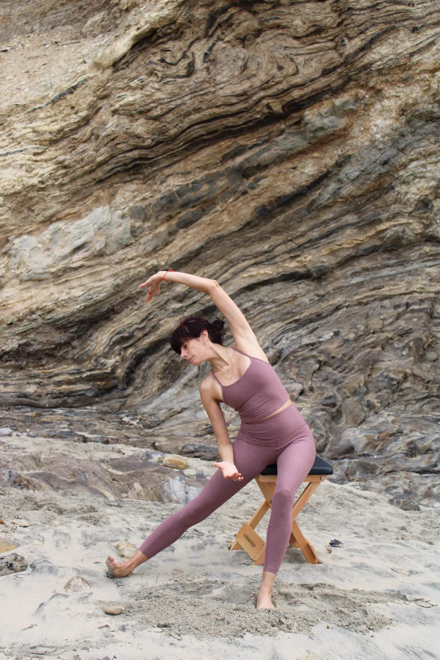 Arpi in a flowing GYROKINESIS®-style backbend on the Gyrotonic® stool, oceanside in Corona Del Mar
